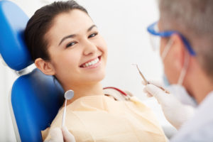 Dentist in Pembroke Pines, FL, treating young, smiling woman